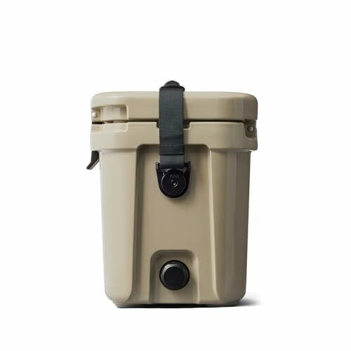 Beige portable cooler with black strap.