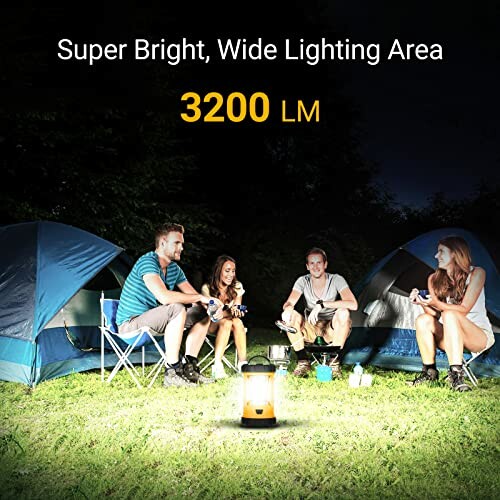 Group of people camping at night with a bright lantern.
