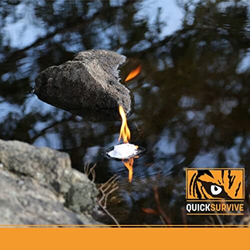 Fire starter burning while floating on water near rocks.