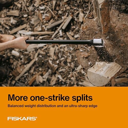 Person using a Fiskars axe to split wood with balanced weight distribution