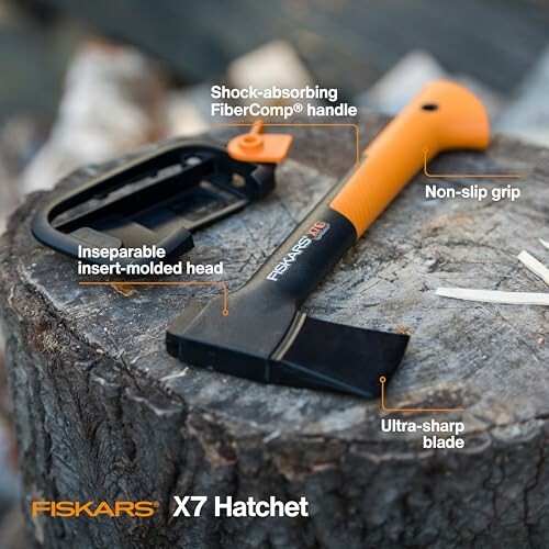 Fiskars X7 hatchet with labeled features on a tree stump.