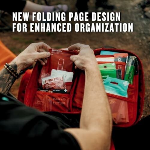 Person organizing a first aid kit with folding page design.