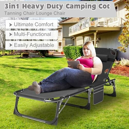 Person relaxing on a heavy-duty camping cot in a backyard setting, demonstrating its comfort and spaciousness.