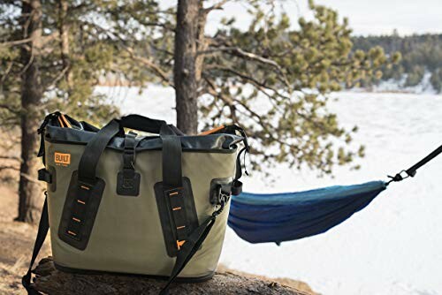 Outdoor bag near hammock in snowy forest setting.