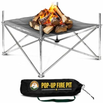 Portable pop-up fire pit with burning logs and carrying bag.