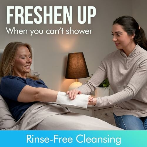 Person assisting another with rinse-free cleansing in bed.