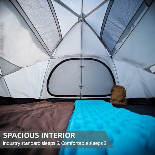 Interior view of a spacious camping tent with sleeping gear.