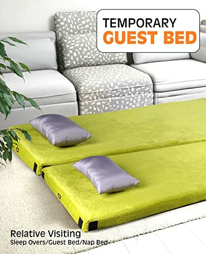 Temporary guest bed with green cushions in a living room setting, illustrating the versatility of the mattress.