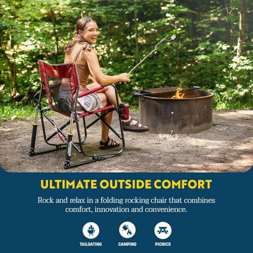 Woman sitting in a folding rocking chair by a campfire.