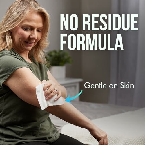 Woman using a no residue wipe on arm.